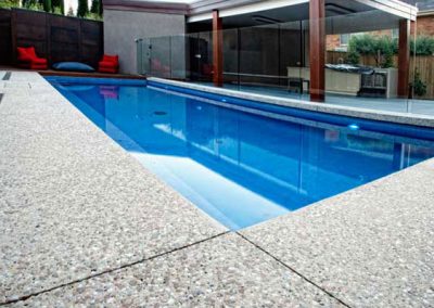 Exposed aggregate pool surround and paving